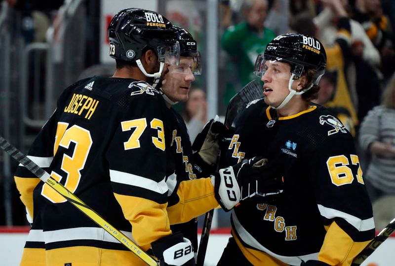 Mar 14, 2024; Pittsburgh, Pennsylvania, USA; Pittsburgh Penguins defensemen Pierre-Olivier Joseph (73) and John Ludvig (middle) congratulate right wing Rickard Rakell (67) on his goal against the San Jose Sharks during the third period at PPG Paints Arena. Pittsburgh won 6-3. Mandatory Credit: Charles LeClaire-USA TODAY Sports