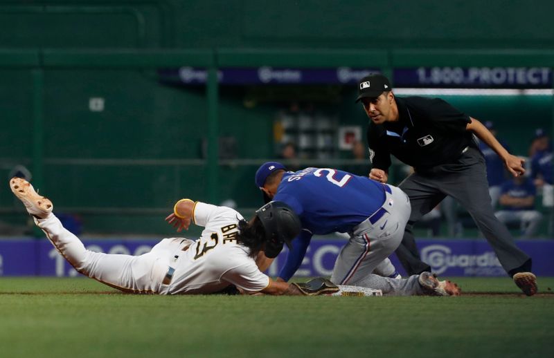 May 23, 2023; Pittsburgh, Pennsylvania, USA; Texas Rangers second baseman Marcus Semien (2) tags Pittsburgh Pirates second baseman Ji Hwan Bae (3) out at second base during the eighth inning at PNC Park. Mandatory Credit: Charles LeClaire-USA TODAY Sports