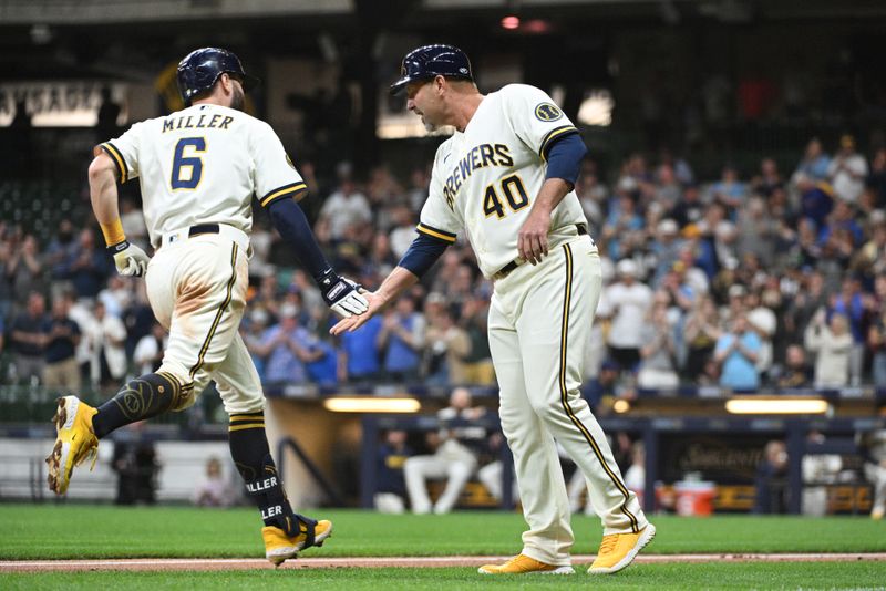 May 23, 2023; Milwaukee, Wisconsin, USA; Milwaukee Brewers second baseman Owen Miller (6) is congratulated by Milwaukee Brewers third base coach Jason Lane (40) after hitting a home run against the Houston Astros in the eighth inning at American Family Field. Mandatory Credit: Michael McLoone-USA TODAY Sports