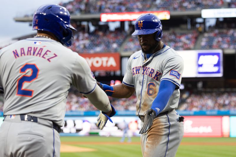 May 16, 2024; Philadelphia, Pennsylvania, USA; New York Mets outfielder Starling Marte (6) high fives catcher Omar Narváez (2) after scoring during the second inning against the Philadelphia Phillies at Citizens Bank Park. Mandatory Credit: Bill Streicher-USA TODAY Sports