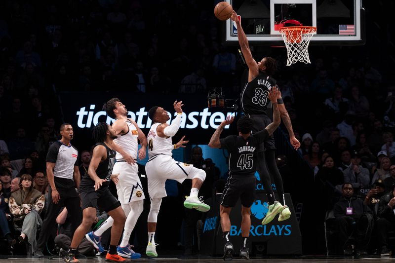 NEW YORK, NEW YORK - OCTOBER 29: Nic Claxton #33 of the Brooklyn Nets blocks the shot of Russell Westbrook #4 of the Denver Nuggets during the first half at Barclays Center on October 29, 2024 in New York City. NOTE TO USER: User expressly acknowledges and agrees that, by downloading and or using this Photograph, user is consenting to the terms and conditions of the Getty Images License Agreement. (Photo by Michelle Farsi/Getty Images)