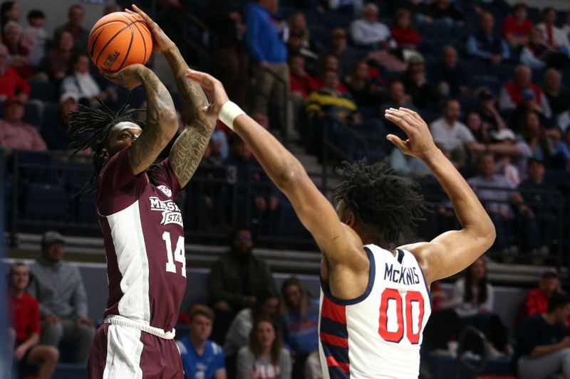 Feb 18, 2023; Oxford, Mississippi, USA; Mississippi State Bulldogs forward Tyler Stevenson (14) shoots as Mississippi Rebels forward Jayveous McKinnis (0) defends during the first half at The Sandy and John Black Pavilion at Ole Miss. Mandatory Credit: Petre Thomas-USA TODAY Sports