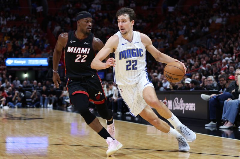 MIAMI, FLORIDA - FEBRUARY 06: Franz Wagner #22 of the Orlando Magic drives against Jimmy Butler #22 of the Miami Heat during the second quarter of the game at Kaseya Center on February 06, 2024 in Miami, Florida. NOTE TO USER: User expressly acknowledges and agrees that, by downloading and or using this photograph, User is consenting to the terms and conditions of the Getty Images License Agreement. (Photo by Megan Briggs/Getty Images)