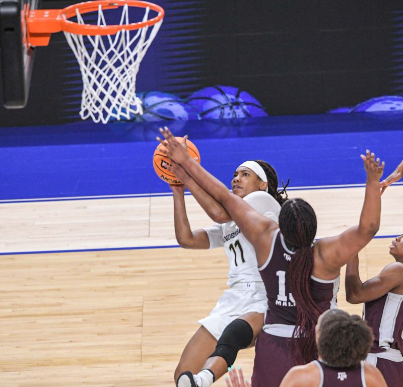 Mar 1, 2023; Greenville, SC, USA; Vanderbilt guard Ciaja Harbison (11) shoots near Texas A&M forward Jada Malone (13) during the first quarter of the SEC Women's Basketball Tournament  at Bon Secours Wellness Arena. Mandatory Credit: Ken Ruinard-USA TODAY Sports