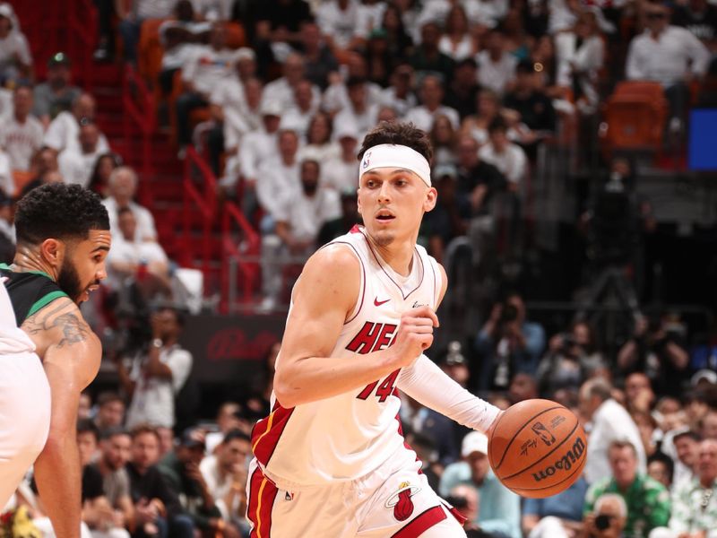 MIAMI, FL - APRIL 27: Tyler Herro #14 of the Miami Heat drives to the basket against Jayson Tatum #0 of the Boston Celtics during the game during Round 1 Game 3 of the 2024 NBA Playoffs on April 27, 2024 at Kaseya Center in Miami, Florida. NOTE TO USER: User expressly acknowledges and agrees that, by downloading and or using this Photograph, user is consenting to the terms and conditions of the Getty Images License Agreement. Mandatory Copyright Notice: Copyright 2024 NBAE (Photo by Issac Baldizon/NBAE via Getty Images)