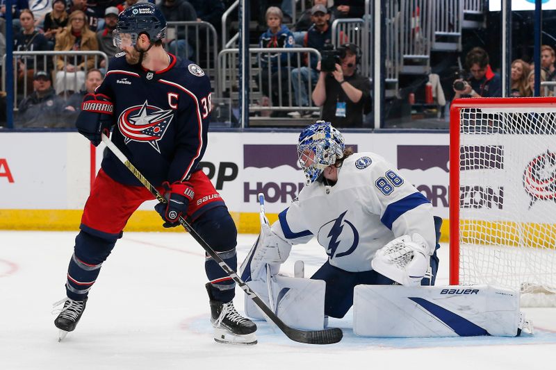 Feb 10, 2024; Columbus, Ohio, USA; Columbus Blue Jackets center Boone Jenner (38) looks tip a shot against the Tampa Bay Lightning during the second period at Nationwide Arena. Mandatory Credit: Russell LaBounty-USA TODAY Sports