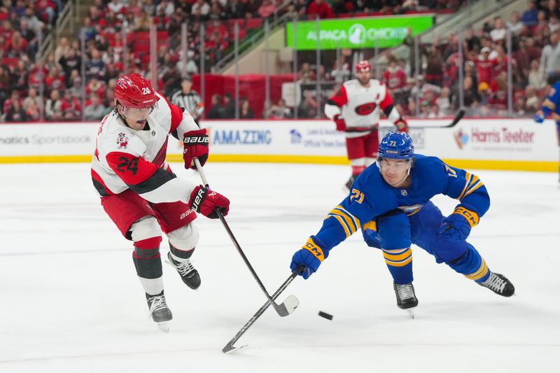 Nov 8, 2025; Raleigh, North Carolina, USA;  Carolina Hurricanes center Seth Jarvis (24) scores empty net goal past Buffalo Sabres center Ryan McLeod (71) during the third period at Lenovo Center. Mandatory Credit: James Guillory-Imagn Images