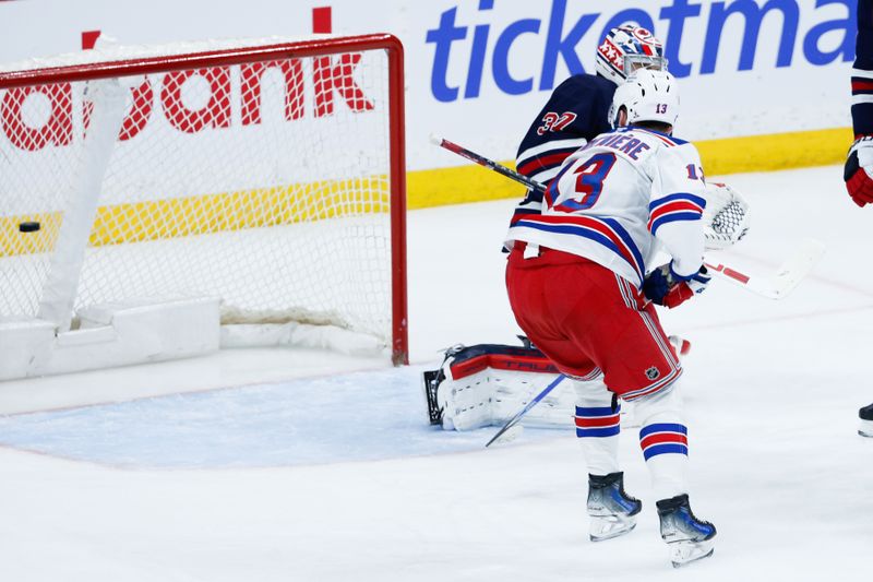 Mar 12, 2026; Winnipeg, Manitoba, CAN; New York Rangers forward Alexis Lafreniere (13) scores on Winnipeg Jets goalie Connor Hellebuyck (37) during the second period at Canada Life Centre. Mandatory Credit: Terrence Lee-Imagn Images