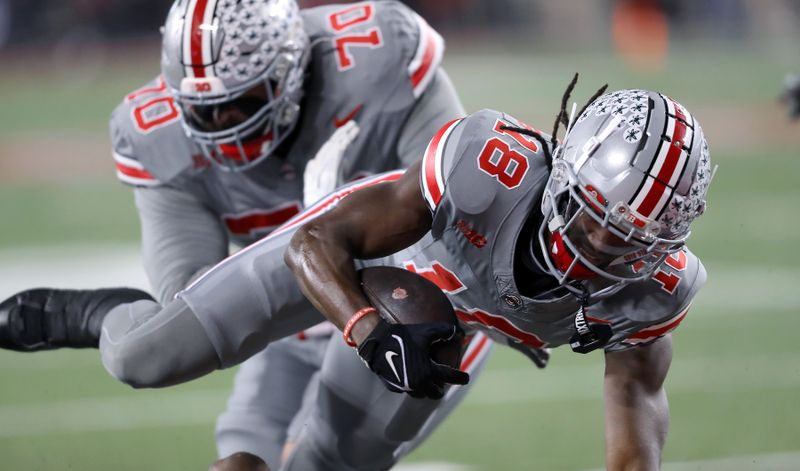 Nov 11, 2023; Columbus, Ohio, USA;  Ohio State Buckeyes wide receiver Marvin Harrison Jr. (18) scores the touchdown during the first quarter against the Michigan State Spartans at Ohio Stadium. Mandatory Credit: Joseph Maiorana-USA TODAY Sports