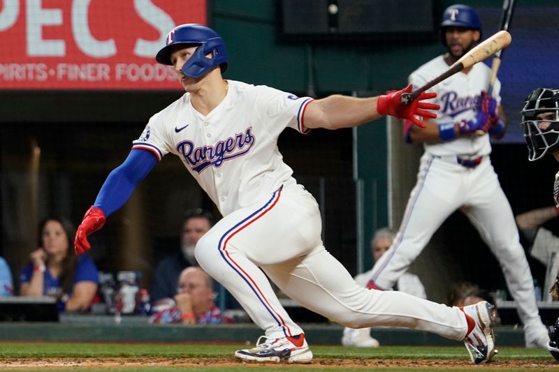 Jul 4, 2024; Arlington, Texas, USA; Texas Rangers outfielder Wyatt Langford (36) hits an RBI single during the sixth inning against the San Diego Padres at Globe Life Field. Mandatory Credit: Raymond Carlin III-USA TODAY Sports