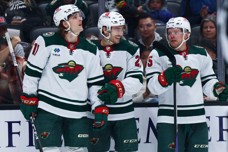 Mar 19, 2024; Anaheim, California, USA; Minnesota Wild center Jacob Lucchini (27) celebrates with his teammates after scoring a goal against the Anaheim Ducks during the third period of a game at Honda Center. Mandatory Credit: Jessica Alcheh-USA TODAY Sports