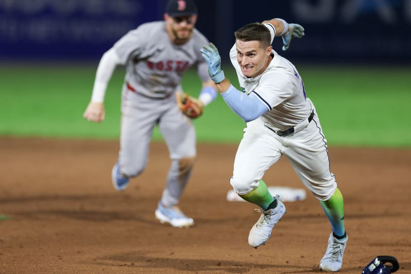 Sep 20, 2025; Tampa, Florida, USA; Tampa Bay Rays left fielder Jake Mangum (28) is caught in a run down against the Boston Red Sox in the eighth inning at George M. Steinbrenner Field. Mandatory Credit: Nathan Ray Seebeck-Imagn Images