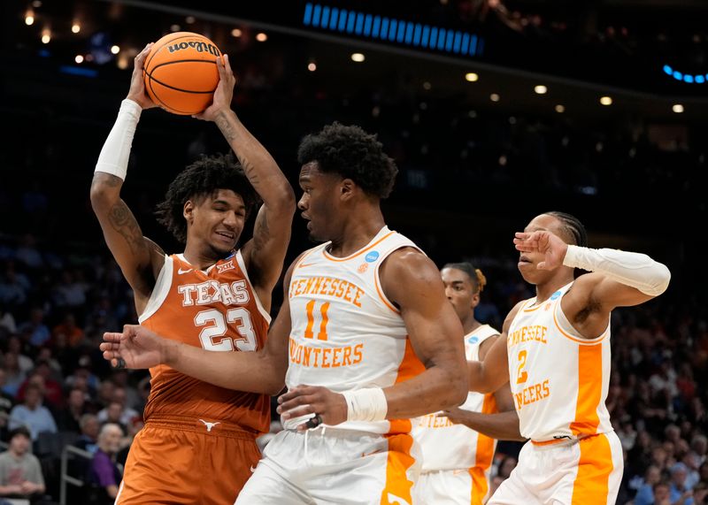 March 23, 2024, Charlotte, NC, USA; Texas Longhorns forward Dillon Mitchell (23) rebounds against Tennessee Volunteers forward Tobe Awaka (11) in the second round of the 2024 NCAA Tournament at the Spectrum Center. Mandatory Credit: Bob Donnan-USA TODAY Sports