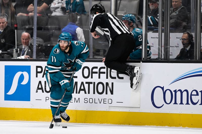 Oct 29, 2024; San Jose, California, USA; San Jose Sharks center Luke Kunin (11) skates with the puck against the Los Angeles Kings in the second period at SAP Center at San Jose. Mandatory Credit: Eakin Howard-Imagn Images