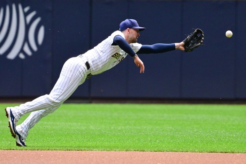 Jun 2, 2024; Milwaukee, Wisconsin, USA; Milwaukee Brewers second baseman Brice Turang (2) can't catch ball in the first inning at American Family Field. Mandatory Credit: Benny Sieu-USA TODAY Sports