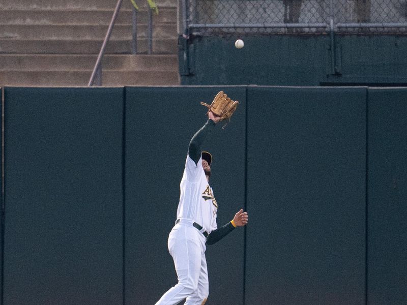 Sep 19, 2023; Oakland, California, USA; Oakland Athletics right fielder Seth Brown (15) fields a fly ball against the Seattle Mariners during the second inning at Oakland-Alameda County Coliseum. Mandatory Credit: Neville E. Guard-USA TODAY Sports