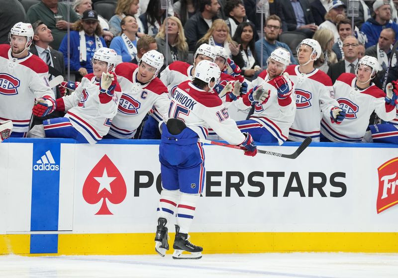 Oct 11, 2023; Toronto, Ontario, CAN; Montreal Canadiens center Alex Newhook (15) celebrates at the bench after scoring a goal against the Toronto Maple Leafs during the second period at Scotiabank Arena. Mandatory Credit: Nick Turchiaro-USA TODAY Sports