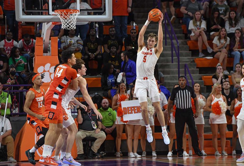 Feb 22, 2023; Clemson, South Carolina, USA; Clemson forward Hunter Tyson (5) rebounds near Syracuse center Jesse Edwards (14) during the second half at Littlejohn Coliseum. Mandatory Credit: Ken Ruinard-USA TODAY Sports