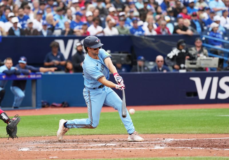 Aug 30, 2023; Toronto, Ontario, CAN; Toronto Blue Jays shortstop Ernie Clement (28) hits an RBI single against the Washington Nationals during the sixth inning at Rogers Centre. Mandatory Credit: Nick Turchiaro-USA TODAY Sports