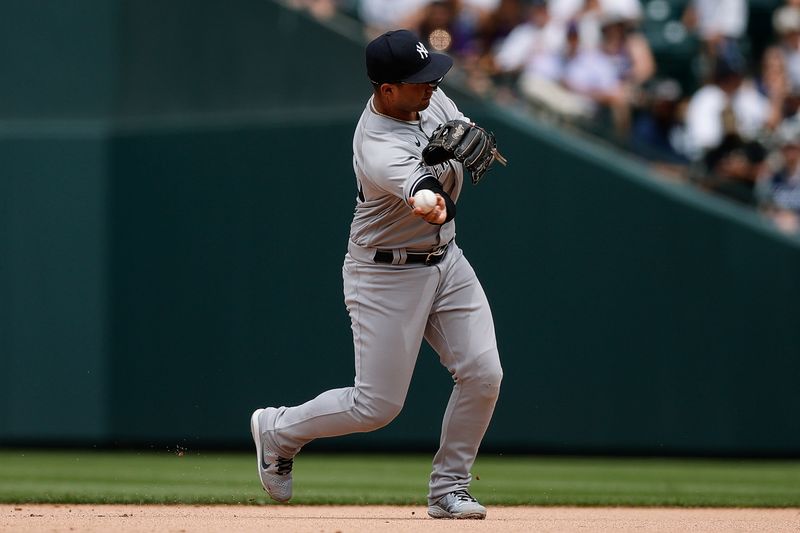 Jul 16, 2023; Denver, Colorado, USA; New York Yankees second baseman Gleyber Torres (25) throws to first for an out in the fifth inning against the Colorado Rockies at Coors Field. Mandatory Credit: Isaiah J. Downing-USA TODAY Sports