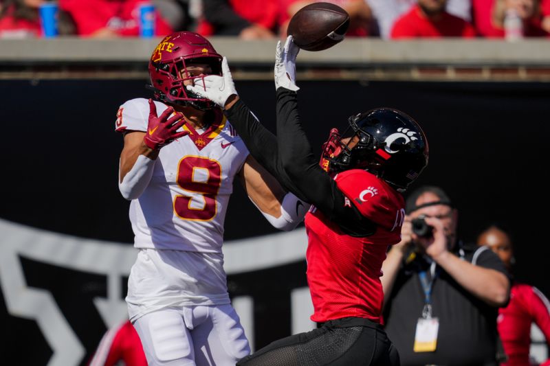 Oct 14, 2023; Cincinnati, Ohio, USA;  Cincinnati Bearcats defensive back Taj Ward (15) breaks up a pass intended for Iowa State Cyclones wide receiver Jayden Higgins (9) in the first half at Nippert Stadium. Mandatory Credit: Aaron Doster-USA TODAY Sports