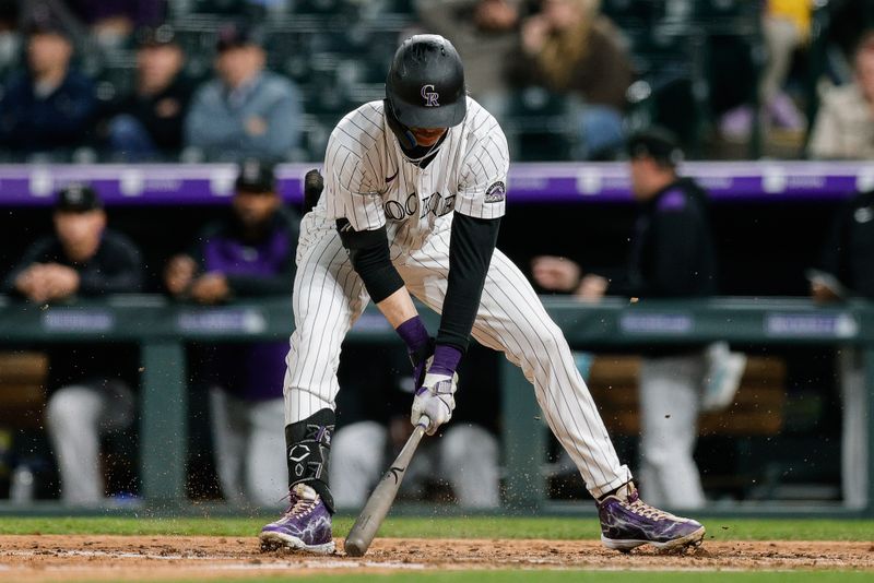 Apr 9, 2025; Denver, Colorado, USA; Colorado Rockies right fielder Zac Veen (13) slams his bat into the ground after striking out in the eighth inning against the Milwaukee Brewers at Coors Field. Mandatory Credit: Isaiah J. Downing-Imagn Images