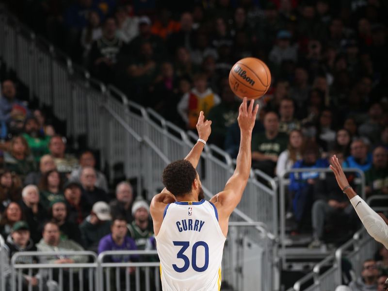 MILWAUKEE, WI - DECEMBER 13: Stephen Curry #30 of the Golden State Warriors shoots a three point basket during the game against the Milwaukee Bucks on December 13, 2022 at the Fiserv Forum Center in Milwaukee, Wisconsin. NOTE TO USER: User expressly acknowledges and agrees that, by downloading and or using this Photograph, user is consenting to the terms and conditions of the Getty Images License Agreement. Mandatory Copyright Notice: Copyright 2022 NBAE (Photo by Gary Dineen/NBAE via Getty Images).