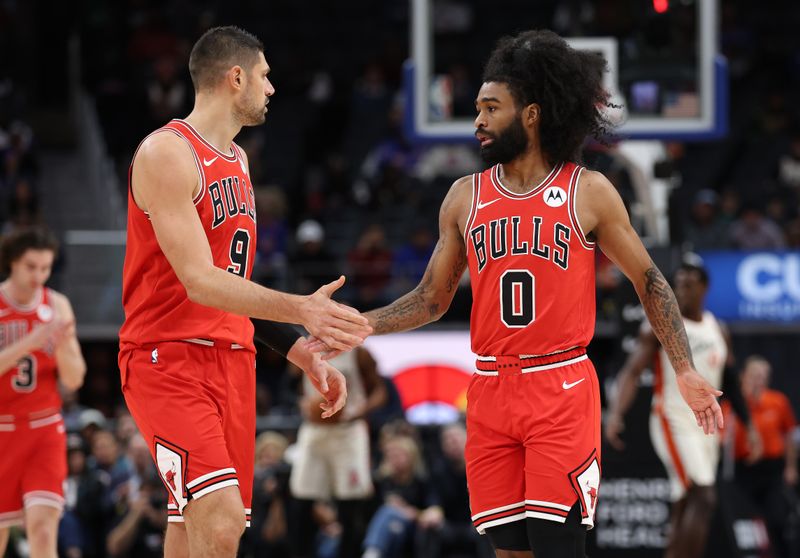 DETROIT, MICHIGAN - NOVEMBER 18: Coby White #0 of the Chicago Bulls celebrates a first half three point basket with Nikola Vucevic #9 while playing the Detroit Pistons at Little Caesars Arena on November 18, 2024 in Detroit, Michigan. NOTE TO USER: User expressly acknowledges and agrees that, by downloading and or using this photograph, User is consenting to the terms and conditions of the Getty Images License. (Photo by Gregory Shamus/Getty Images)