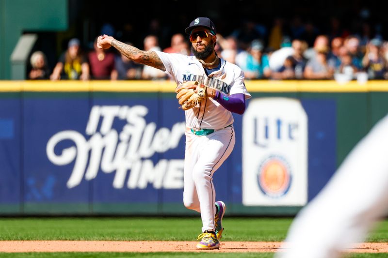 Aug 28, 2024; Seattle, Washington, USA; Seattle Mariners shortstop J.P. Crawford (3) throws to first for an out against the Tampa Bay Rays during the eighth inning at T-Mobile Park. Mandatory Credit: Joe Nicholson-USA TODAY Sports