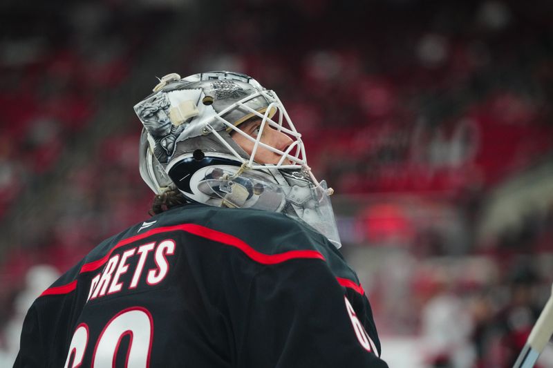 Nov 16, 2024; Raleigh, North Carolina, USA;  Carolina Hurricanes goaltender Yaniv Perets (60) looks on during the warmups before the game against the Ottawa Senators at Lenovo Center. Mandatory Credit: James Guillory-Imagn Images