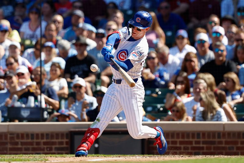 Aug 21, 2025; Chicago, Illinois, USA; Chicago Cubs center fielder Pete Crow-Armstrong (4) hits an RBI-sacrifice fly against the Milwaukee Brewers during the fifth inning at Wrigley Field. Mandatory Credit: Kamil Krzaczynski-Imagn Images