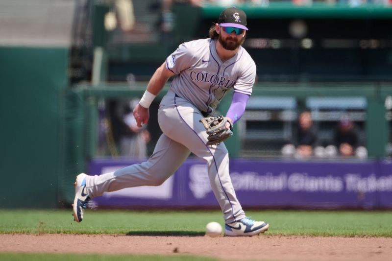 Jul 28, 2024; San Francisco, California, USA; Colorado Rockies infielder Brendan Rodgers (7) runs to field a ground ball against the San Francisco Giants during the fourth inning at Oracle Park. Mandatory Credit: Robert Edwards-USA TODAY Sports