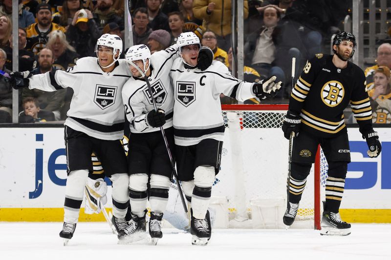 Feb 17, 2024; Boston, Massachusetts, USA; Los Angeles Kings center Anze Kopitar (11) celebrates his game tying goal with left wing Kevin Fiala (22) and defenseman Andreas Englund (5) as Boston Bruins defenseman Derek Forbort (28) skates away during the third period at TD Garden. Mandatory Credit: Winslow Townson-USA TODAY Sports