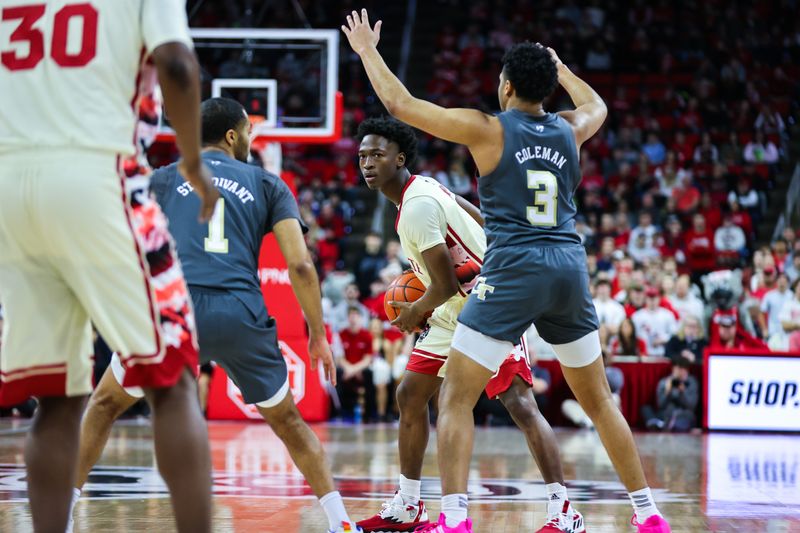 Feb 4, 2023; Raleigh, North Carolina, USA; North Carolina State Wolfpack guard Jarkel Joiner (1) looks to make a play defended by Georgia Tech Yellow Jackets guard Dallan Coleman (3) during first half against at PNC Arena. Mandatory Credit: Jaylynn Nash-USA TODAY Sports