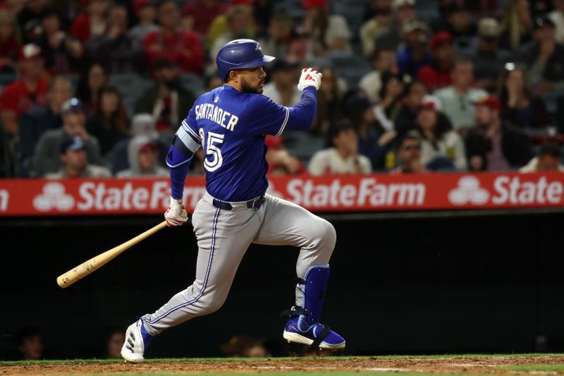 May 7, 2025; Anaheim, California, USA;  Toronto Blue Jays designated hitter Anthony Santander (25) hits an RBI single during the sixth inning against the Los Angeles Angels at Angel Stadium. Mandatory Credit: Kiyoshi Mio-Imagn Images