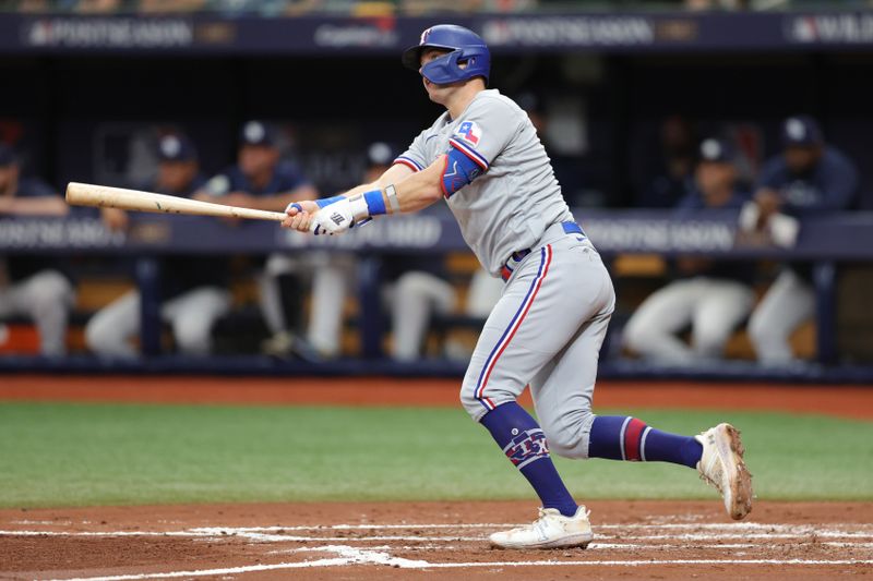 Oct 4, 2023; St. Petersburg, Florida, USA; Texas Rangers third baseman Josh Jung (6) hits a double against the Tampa Bay Rays in the third inning during game two of the Wildcard series for the 2023 MLB playoffs at Tropicana Field. Mandatory Credit: Nathan Ray Seebeck-USA TODAY Sports