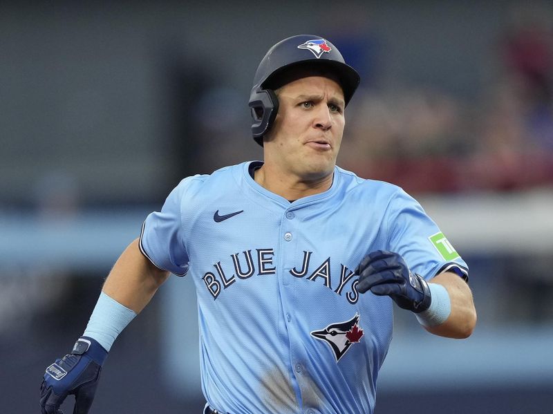 May 22, 2024; Toronto, Ontario, CAN; Toronto Blue Jays center fielder Daulton Varsho (25) runs to third base on a two-run triple against the Chicago White Sox during the second inning at Rogers Centre. Mandatory Credit: John E. Sokolowski-USA TODAY Sports