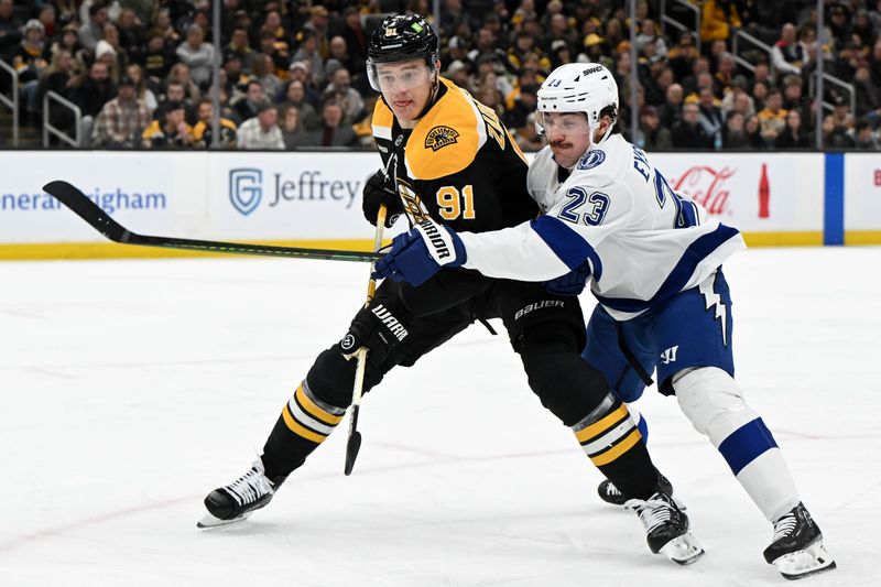 Jan 14, 2025; Boston, Massachusetts, USA; Boston Bruins defenseman Nikita Zadorov (91) and Tampa Bay Lightning center Michael Eyssimont (23) battle for position during the second period at the TD Garden. Mandatory Credit: Brian Fluharty-Imagn Images