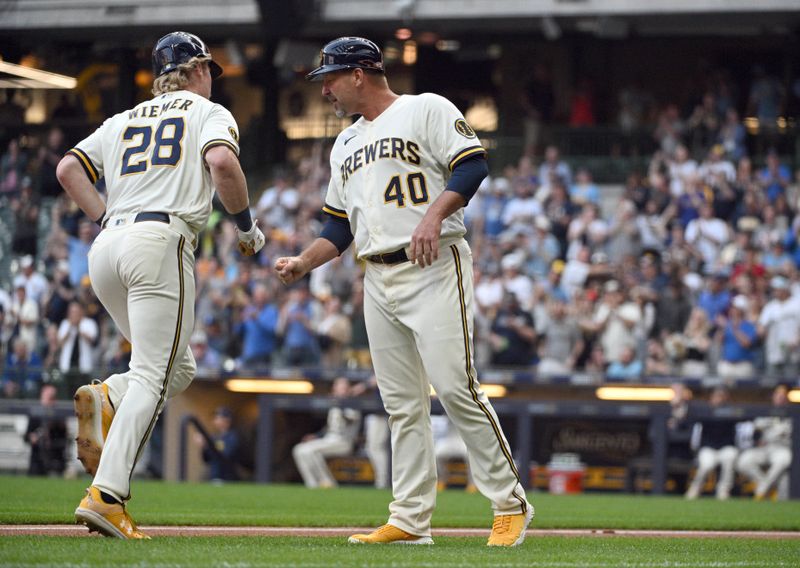 May 23, 2023; Milwaukee, Wisconsin, USA; Milwaukee Brewers right fielder Joey Wiemer (28) celebrates with Milwaukee Brewers third base coach Jason Lane (40) after hitting a home run against the Houston Astros in the third inning at American Family Field. Mandatory Credit: Michael McLoone-USA TODAY Sports