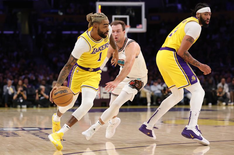 LOS ANGELES, CALIFORNIA - NOVEMBER 13: D'Angelo Russell #1 of the Los Angeles Lakers dribbles the ball past Luke Kennard #10 of the Memphis Grizzlies during the second quarter at Crypto.com Arena on November 13, 2024 in Los Angeles, California. NOTE TO USER: User expressly acknowledges and agrees that, by downloading and or using this photograph, User is consenting to the terms and conditions of the Getty Images License Agreement.  (Photo by Harry How/Getty Images)