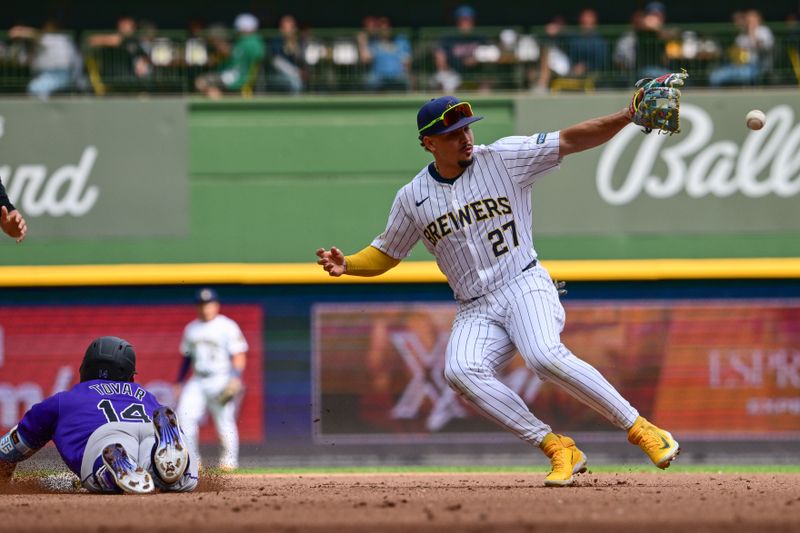 Sep 8, 2024; Milwaukee, Wisconsin, USA; Colorado Rockies shortstop Ezequiel Tovar (14) slides into second base with a double as Milwaukee Brewers shortstop Willy Adames (27) gets the ball in the fifth inning at American Family Field. Mandatory Credit: Benny Sieu-Imagn Images