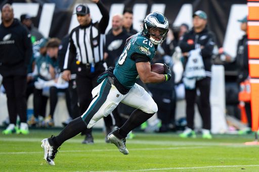 Philadelphia Eagles running back Saquon Barkley (26) gets up and runs with the ball, but will be ruled down during the NFL football game against the Carolina Panthers, Sunday, Dec. 8, 2024, in Philadelphia. Saquon Barkley sets the Philadelphia Eagles single season rushing record on this run.The Eagles won 22-16. (AP Photo/Chris Szagola)