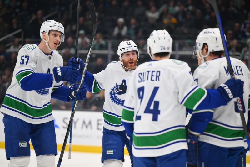 Feb 22, 2024; Seattle, Washington, USA; Vancouver Canucks defenseman Tyler Myers (57) and defenseman Ian Cole (82) celebrate after a goal scored against the Seattle Kraken by right wing Conor Garland (8) (not pictured) during the first period at Climate Pledge Arena. Mandatory Credit: Steven Bisig-USA TODAY Sports