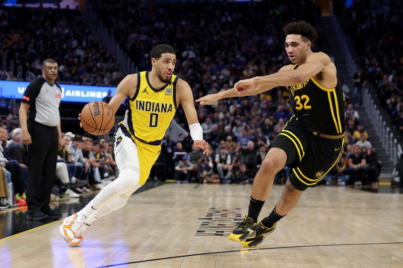 SAN FRANCISCO, CALIFORNIA - MARCH 22: Tyrese Haliburton #0 of the Indiana Pacers is guarded by Trayce Jackson-Davis #32 Golden State Warriors in the second half at Chase Center on March 22, 2024 in San Francisco, California. NOTE TO USER: User expressly acknowledges and agrees that, by downloading and or using this photograph, User is consenting to the terms and conditions of the Getty Images License Agreement.  (Photo by Ezra Shaw/Getty Images)