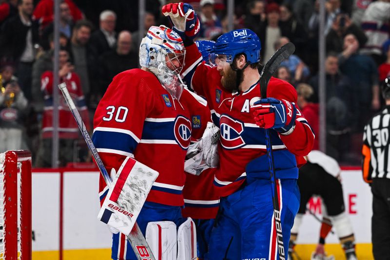 Feb 13, 2024; Montreal, Quebec, CAN; Montreal Canadiens defenseman David Savard (58) celebrates the shootout win against the Anaheim Ducks with goalie Cayden Primeau (30) at Bell Centre. Mandatory Credit: David Kirouac-USA TODAY Sports