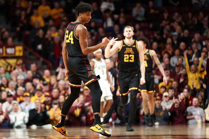 Feb 6, 2024; Minneapolis, Minnesota, USA; Minnesota Golden Gophers guard Cam Christie (24) celebrates after drawing a foul on his three-point shot against the Michigan State Spartans during the second half at Williams Arena. Mandatory Credit: Matt Krohn-USA TODAY Sports