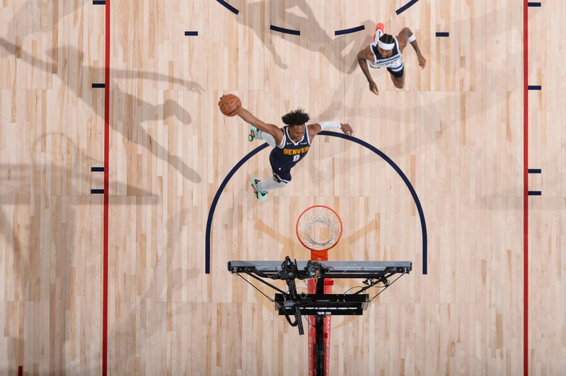 DENVER, CO - APRIL 10: Peyton Watson #8 of the Denver Nuggets dunks the ball during the game against the Minnesota Timberwolves on April 10, 2024 at the Ball Arena in Denver, Colorado. NOTE TO USER: User expressly acknowledges and agrees that, by downloading and/or using this Photograph, user is consenting to the terms and conditions of the Getty Images License Agreement. Mandatory Copyright Notice: Copyright 2024 NBAE (Photo by Bart Young/NBAE via Getty Images)