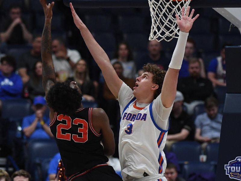 Mar 14, 2024; Nashville, TN, USA; Florida Gators center Micah Handlogten (3) defends a shot by Georgia Bulldogs forward Jalen DeLoach (23) during the first half at Bridgestone Arena. Mandatory Credit: Christopher Hanewinckel-USA TODAY Sports