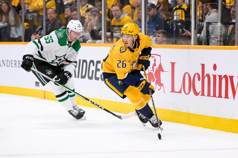 Oct 10, 2024; Nashville, Tennessee, USA; Nashville Predators center Philip Tomasino (26) skates past Dallas Stars defenseman Thomas Harley (55) during the first period at Bridgestone Arena. Mandatory Credit: Steve Roberts-Imagn Images