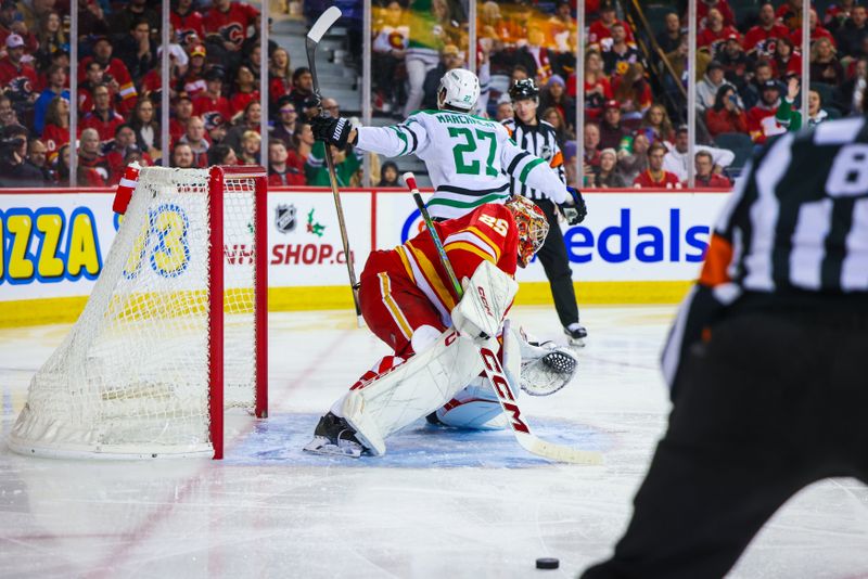 Nov 30, 2023; Calgary, Alberta, CAN; Dallas Stars left wing Mason Marchment (27) scores a goal on a penalty shot against Calgary Flames goaltender Jacob Markstrom (25) during the third period at Scotiabank Saddledome. Mandatory Credit: Sergei Belski-USA TODAY Sports